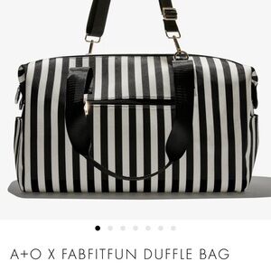 Chic Black and White Striped Travel Duffle Bag with Leather Accents